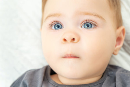 Extreme close-up portrait of a ten-month-old baby boy. Blue eyes red haired little child