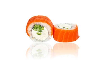 Close up image of classic philadelphia sushi rolls with salmon, cheese and cucumber isolated on white background with reflection. Delicious Japanese seafood.の写真素材
