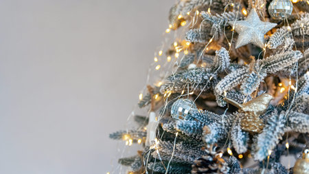 Stylish beautiful decorated Christmas tree close-up on grey color background. Modern christmas tree...