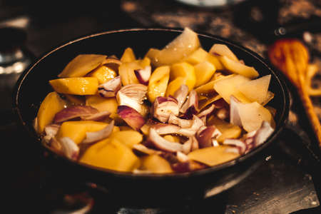 Onion, potatoes and oil, ingredients before cooking Spanish omelette, ready to eatの写真素材