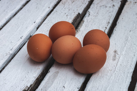 Five eggs on a white table