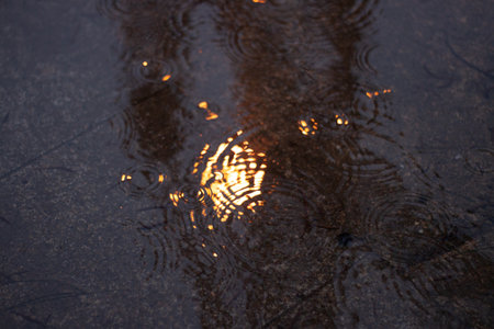 Puddle of water in a street in Barcelona, after rainingの写真素材