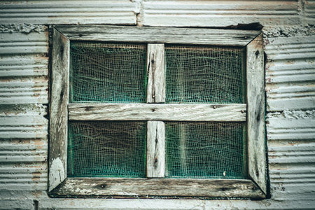 Weathered Wooden Window with Mesh Detailの写真素材