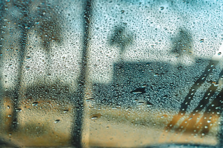 Raindrops on Car Window with Blurry Background View
