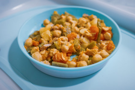 Homemade chickpea and vegetable stew in blue bowl"の写真素材