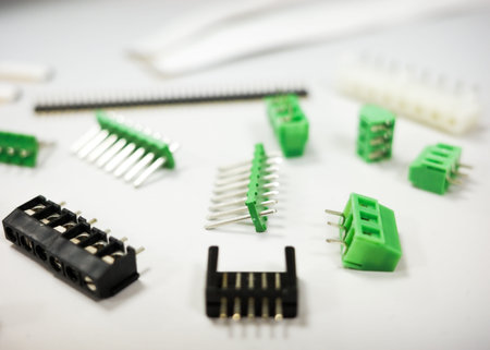 Assorted electronic connectors and terminal blocks on white background, close-up of electronic components for PCB assembly.の写真素材