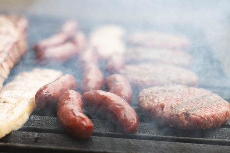 Mixed barbecue with smoke and grilled meatの写真素材