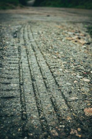 Tire tracks on a muddy rural road after rainの写真素材