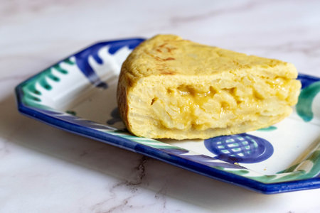 Creamy Spanish Potato Omelette Slice on Colorful Ceramic Plate