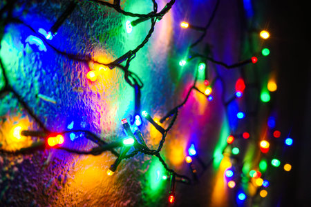 Colorful Christmas LED string lights on a wall festive holiday decoration