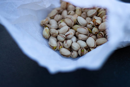 Pistachio nuts inside paper bag close-up
