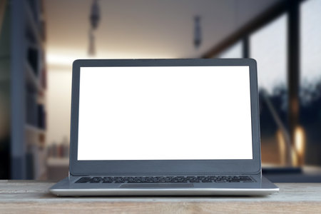 Laptop computer on desk at office or co-working space, Laptop with white blank on screen and blurred background , working space concept.の写真素材