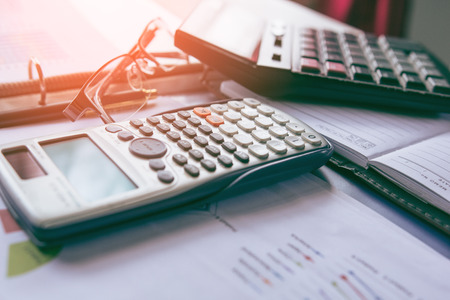 Pen with business graphs and charts report , calculator on desk of financial planing. Financial abstract concepts.の写真素材