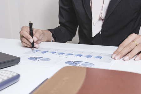 Businessman check seriously analyzes a finance report investor colleagues discussing new plan financial graph data. bank managers task. Concept business and finance ,Account analyzes planingの写真素材