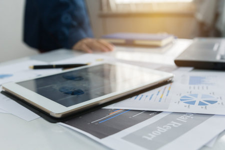 Taplad with business graphs and charts report , calculator on desk of financial planing. Financial abstract concepts.の写真素材