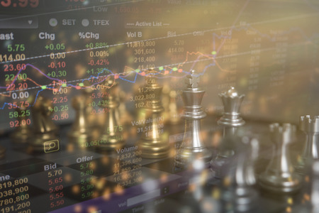 Chess board game concept of business ideas and competition and strategy plan success meaning, Stock financial statistic graph analysis data concept.の写真素材