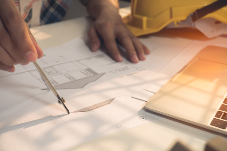 Architecture drawing plan on blue print with architect tools on his workplaceの写真素材