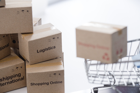 Idea of shopping online and service / e-commerce concept. Stack boxes on laptop for Customer can buy from electronic internet.の写真素材