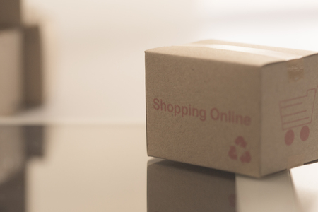 Idea of shopping online and service / e-commerce concept. Stack boxes on laptop for Customer can buy from electronic internet.の写真素材