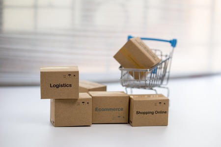 Idea of shopping online and service / e-commerce concept. Stack boxes on laptop for Customer can buy from electronic internet and the messenger will deliver.の写真素材