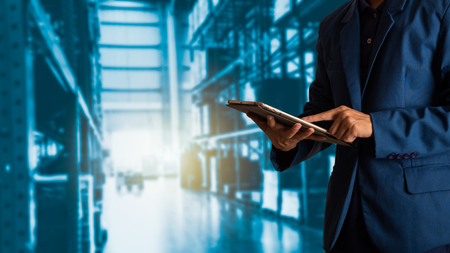Businessman manager using tablet check and control for workers with Modern Trade warehouse logistics.の写真素材