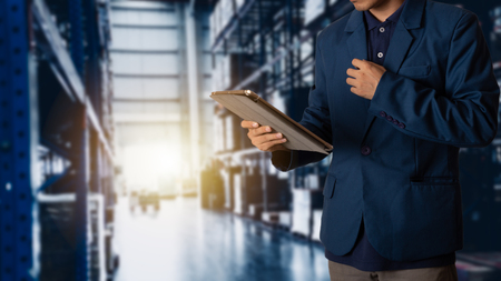 Businessman manager using tablet check and control for workers with Modern Trade warehouse logistics.の写真素材
