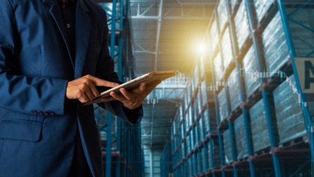 Businessman manager using tablet check and control for workers with Modern Trade warehouse logistics. Industry 4.0 concept,planning of logistics, Transportation within the country and Global.の写真素材