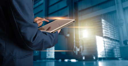 Businessman manager using tablet check and control for workers with Modern Trade warehouse logistics. Industry 4.0 conceptの写真素材
