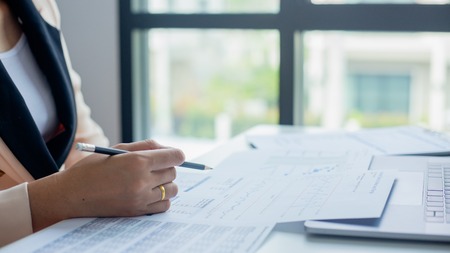 Businesswoman calculate about cost and doing finance at office, Finance managers task,Concept business and finance investmentの写真素材