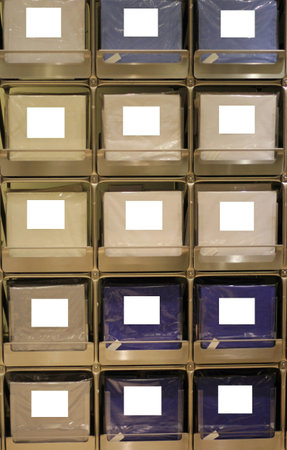 Rows of boxes with white empty labels on the shelvesの写真素材