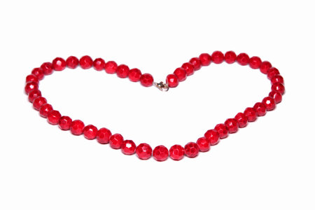 The heart of the red beads on a white backgroundの写真素材