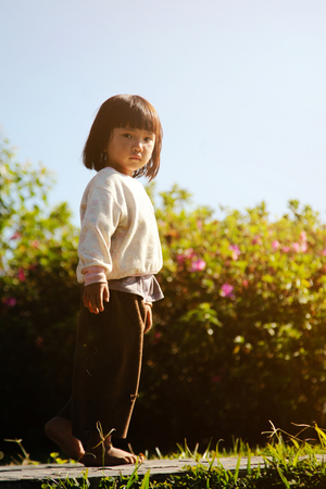JANUARY 9, 2013 - CHIANGMAI THAILAND : Rural girl in flower garden with sunlight in the morning.のeditorial素材