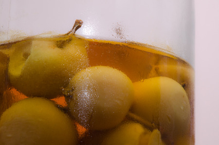 Canned apples in a bottle / Canned apples in a bottle with water droplets on glassの写真素材