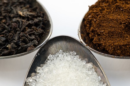 Tea, coffee and sugar in a spoon close-upの写真素材