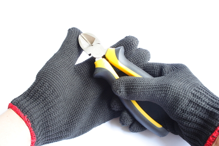 Gloved hand and a cutting pliersの写真素材
