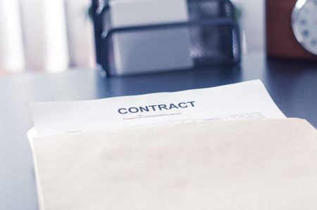 Contract in a brown envelope on a black table