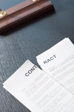 Terminate the contract on a black table with a penの写真素材