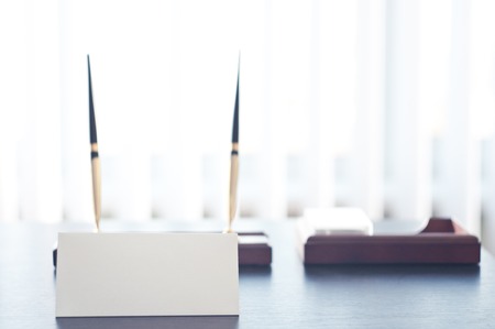 White triangular sign for the label standing on a table. Room for you text.の写真素材