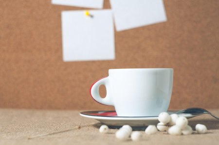 Cup of hot drink with coffee beans.