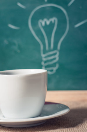 coffee cup and business idea on wooden table.の写真素材