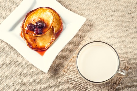 pancakes with jam and coffee on burlap background.の写真素材
