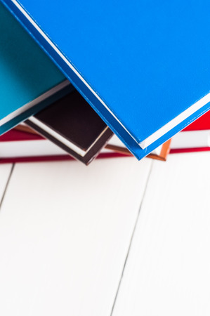 stack of books lying on white table.の写真素材