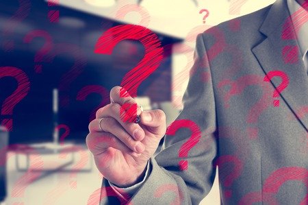 Businessman drawing a red question mark. Business concept.の写真素材
