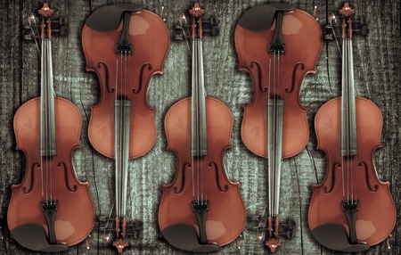 Violin on grey wooden background. With space for text writing.の写真素材