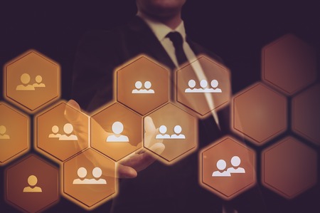 Hand carrying businessman icon network - HR,HRM,MLM, teamwork and leadership concept.の写真素材