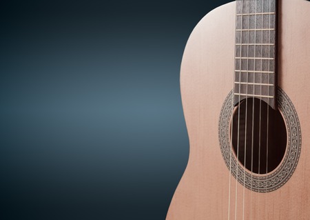 Part of a blue acoustic guitar on black background.の写真素材