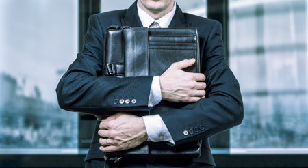 Concept of a stressed businessman under pressure. Fear of job lossの写真素材