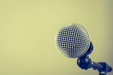 the classic vintage silver microphone on green background.の写真素材