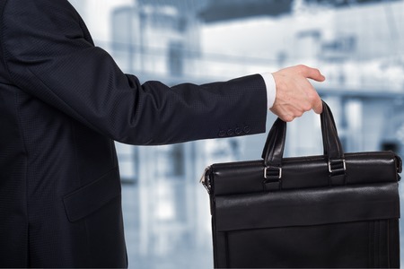 Concept of partnership and teamwork . Businessman passes the case.の写真素材