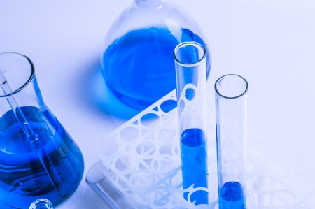 Science laboratory test tubes, equipment filled with blue liquidの写真素材